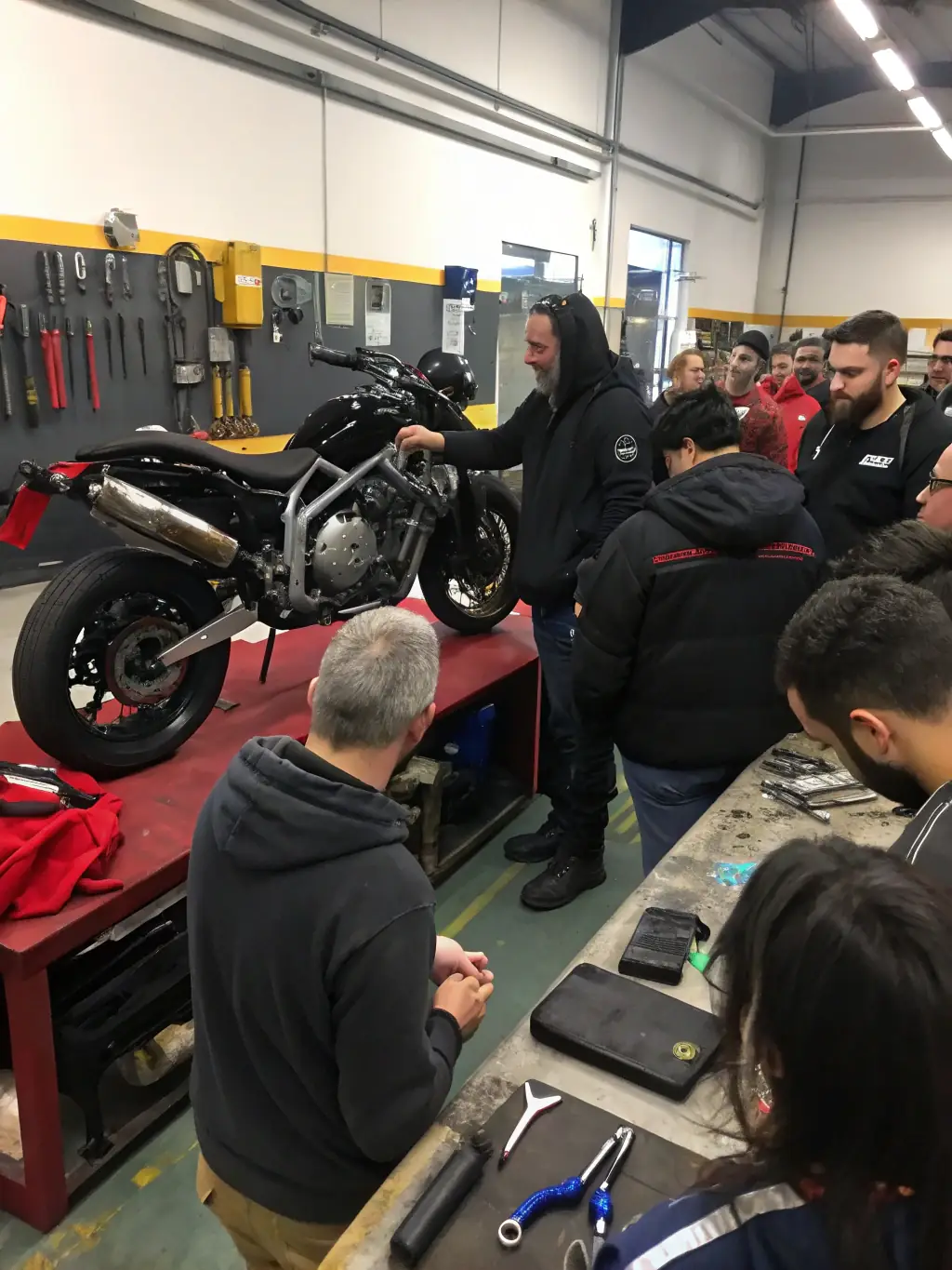 Participants attending a quad biking workshop, learning about maintenance, repair, and advanced riding techniques from experienced professionals.
